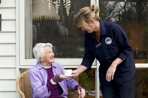 Borough of Queenscliffe community care worker giving cup of tea to elderly lady
