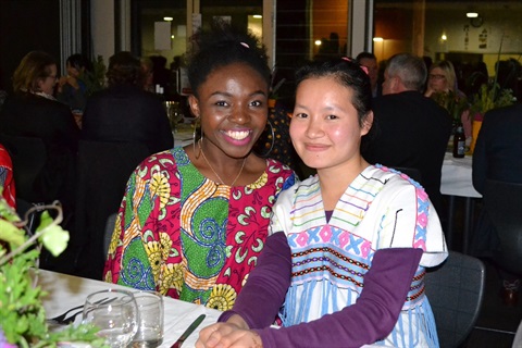 Two teenage girls smiling in a photo at Refugee Welcome Zone evening