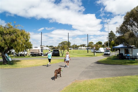 Park guests walking their dog at Queenscliff Recreation Reserve