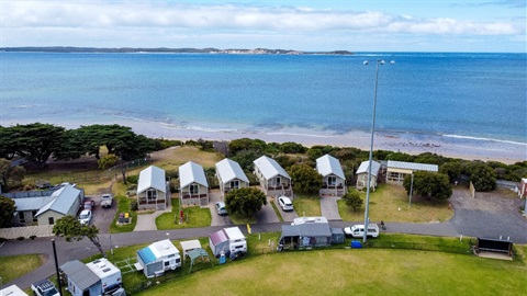 Aerial shot of cabins by the water at Queenscliff Recreation Reserve