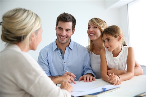 Family of three asking a woman for advice on building plans