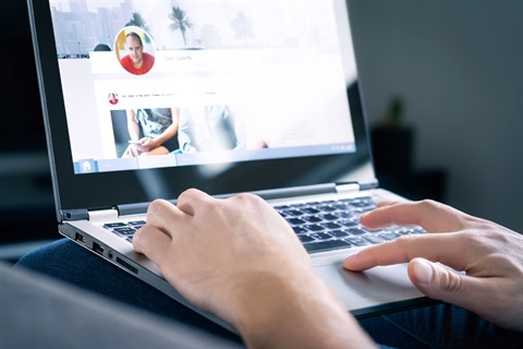 A person updating their social media profile on their computer