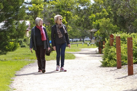 Two women walk along Thwaites Walk in Queenscliff