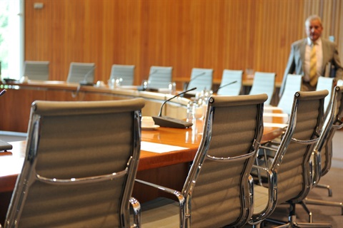 Empty chairs around a meeting table
