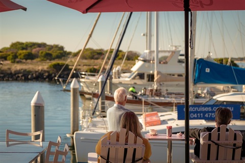 Visitors to the Queenscliff Harbour looking out over the water