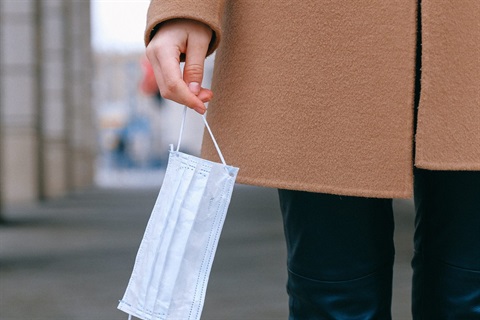 Woman holding surgical mask